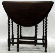 Oak oval top gateleg table with moulded edge, on turned spiral supports united by stretchers,