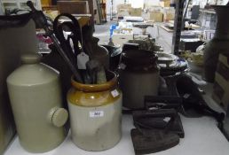 Three stoneware hot water bottles, two flat irons one marked 'Carron 5',