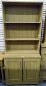 Modern pine-effect three-tier bookcase and a matching side cupboard,
