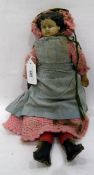 Papier mache material doll with painted face,