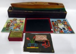 Wooden model of a motor boat with clockwork motor and two Louis Wain puzzles,