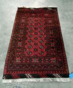 Bokhara style wool rug with eight rows of interlinked elephant's foot guls,