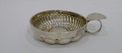 19th century French silver wine taster, half-fluted and embossed with roundels, ring loop handle,