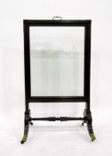 Georgian mahogany firescreen with glazed panel, on splayed legs with brass cap castors,