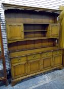 Reproduction stained fruitwood dresser, the three-tier platerack with pair of cupboards,