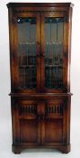 Georgian style oak double corner cupboard, the upper section with glazed leaded light panel doors,