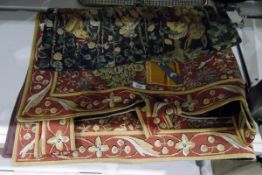 Tapestry wall hanging depicting medieval figures and with roaring lion and another tapestry wall