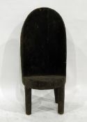 Nagaland chief's chair hollowed from a tree trunk, the back carved with coiled serpents, skull, etc,