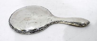 Early 20th century silver-backed dressing mirror, circular, with scroll relief border,
