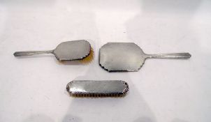 Silver mirror and brush set, of shaped form with engine-turned decoration,