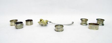 Quantity of six predominantly silver napkin rings and an Austrian silver sifter spoon,