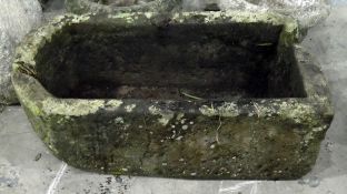 Old stone trough of rectangular form with curved end,