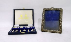 Late 19th/early 20th century silver photograph frame with repousse decoration and a set of six