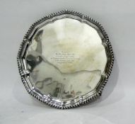 Early 20th century circular silver salver with gadrooned border 'Presented to Wor. Bro.