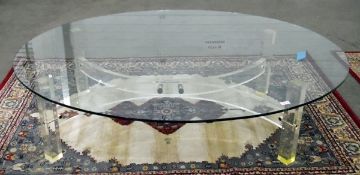 Modern oval glass-topped coffee table on a perspex base