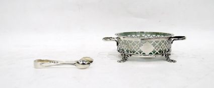 Early 20th century silver wine coaster with glass liner, two-handled with pierced fretwork,