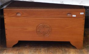 Camphorwood chest containing various linens, scarves, a doll, etc