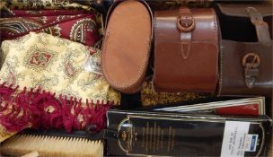 Faux-leather case containing various gentlemen's wool and paisley scarves, patterned
