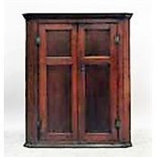 19th century oak alcove cupboard enclosed by two panelled doors with brass H-hinges, 94cm wide x