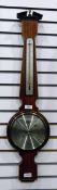 Modern barometer made by Comitti of London, with temperature, within a veneered frame with a