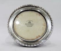 Early 20th century silver photograph frame, circular with husk border