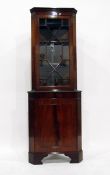 Georgian style mahogany double corner cupboard, the upper section with astragal-glazed door