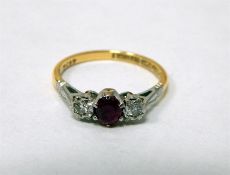 18ct gold three-stone diamond and ruby ring, set c
