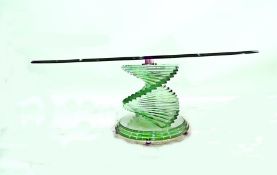 Elliptical plate glass coffee table on a faceted a