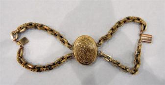 Gold coloured metal locket bracelet, the oval floral and foliate engraved locket supported by