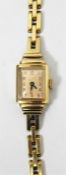 Lady's 14K gold wristwatch with rectangular buff d