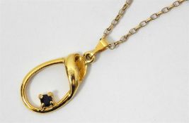 Gold-coloured pendant with circular sapphire stone