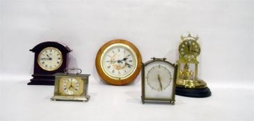 Modern brass 400-day mantel clock under a plastic