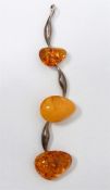 Silver drop pendant with two heat treated amber ca