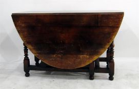 Oak oval fall-flap gateleg dining table on baluste