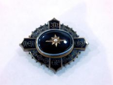 Victorian black enamel silver and gold coloured metal mourning brooch, oval, with oval onyx set to