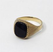 Gold signet ring set with black rectangular stone