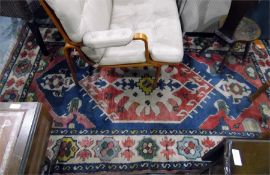 Modern wool rug with white ground, central lozenge in red, blue and green, lozenge and foliate