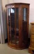 Glazed oak bowfront corner cupboard with adjustabl