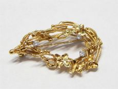 Gold and diamond brooch, floral decorated, with th