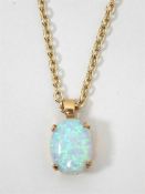 9ct gold and oval opal cabochon pendant, on a silv