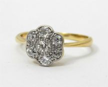 18ct gold and diamond flowerhead-pattern ring set an arrangement of seven stones in illusory six-