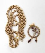 A gold and amethyst circular pendant on chain, floral decorated