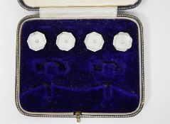 A set of four 9ct white gold and enamel studs in box