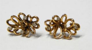 Pair of gold and diamond flower-shaped earrings (u