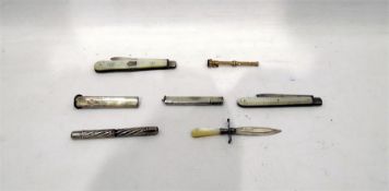 Two silver fruit knives, a bookmark, pencil, etc