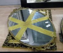 Oval mirror within a gilt reproduction frame and a