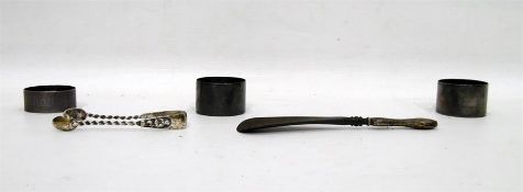 Three silver napkin rings, a pair of silver sugar