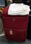 Trip suitcase and a quantity of table linen