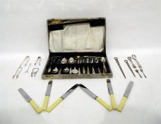 Four silver sugar tongs, a pickle fork and sundry silver plated flatware (boxed)