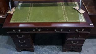 Reproduction mahogany pedestal desk with green lea
